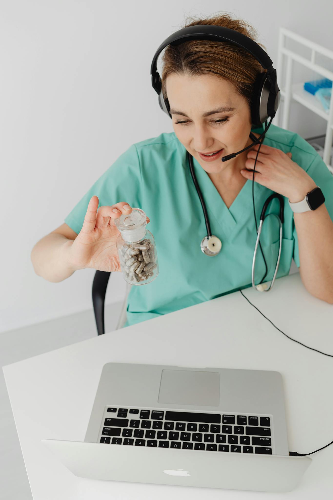 Healthcare practitioner discusses medication in an online consultation, showcasing telemedicine.